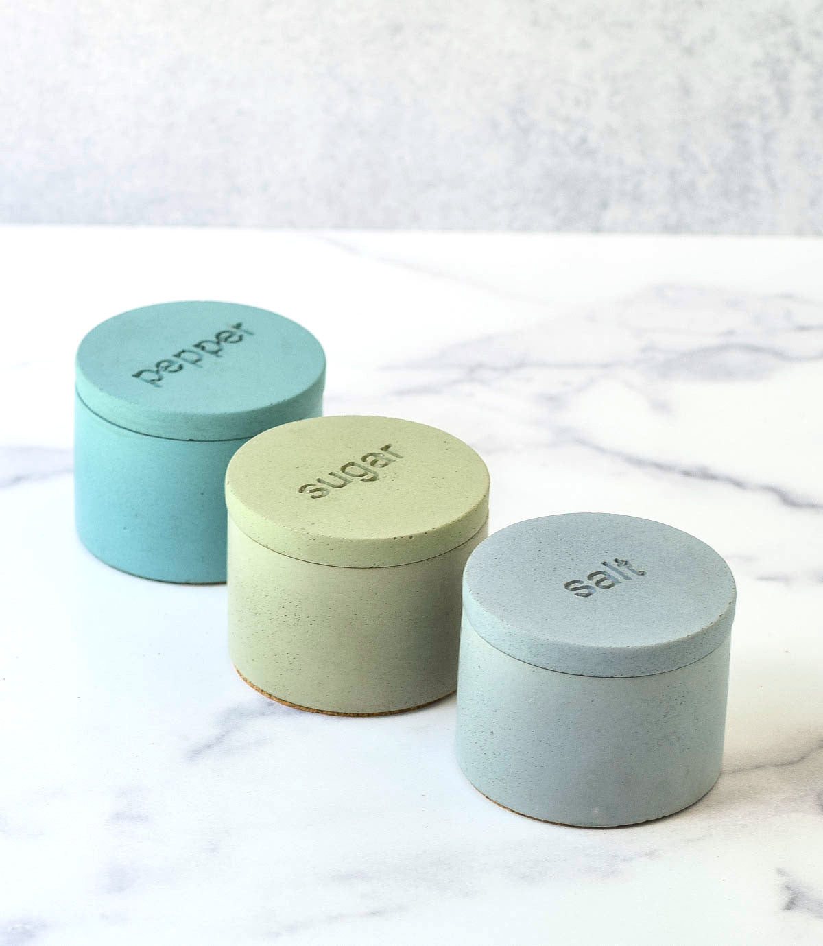 Gray salt cellar, mint sugar cellar and teal pepper cellar.