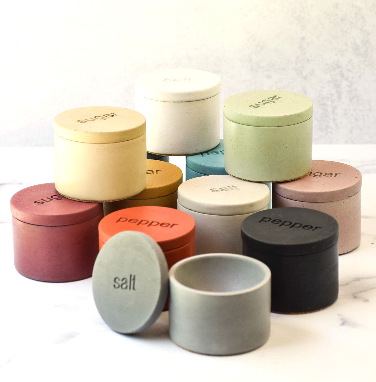 salt, pepper and sugar cellars various colors with lids
